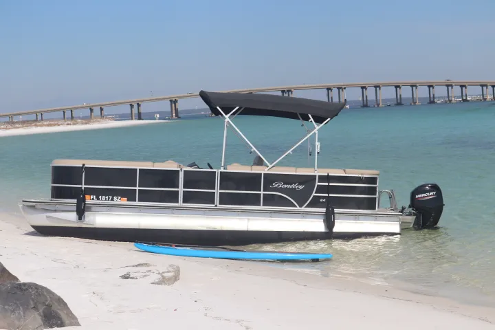 a boat sitting on top of a sandy beach