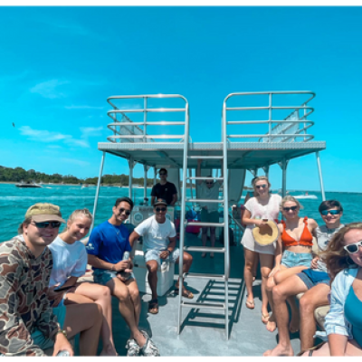 a group of people standing in front of a body of water