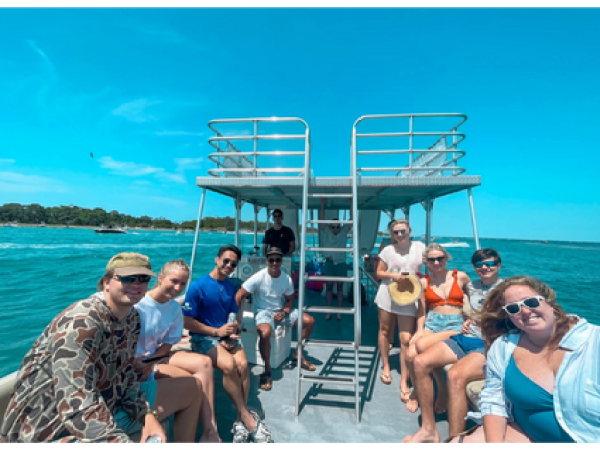 a group of people standing in front of a body of water